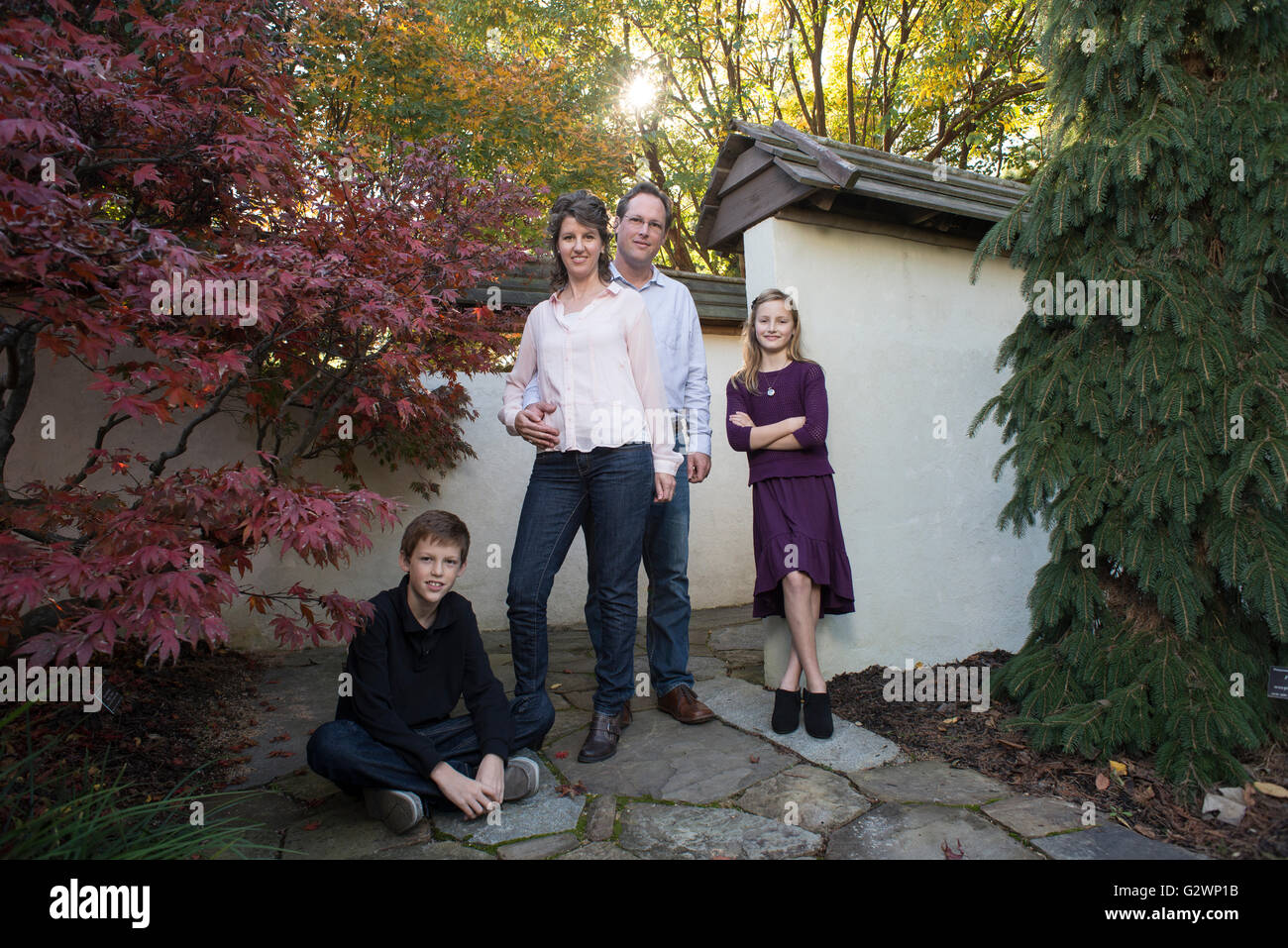 A Caucasian family of four pose for photographs at JC Arboretum in Raleigh, NC, USA. Stock Photo