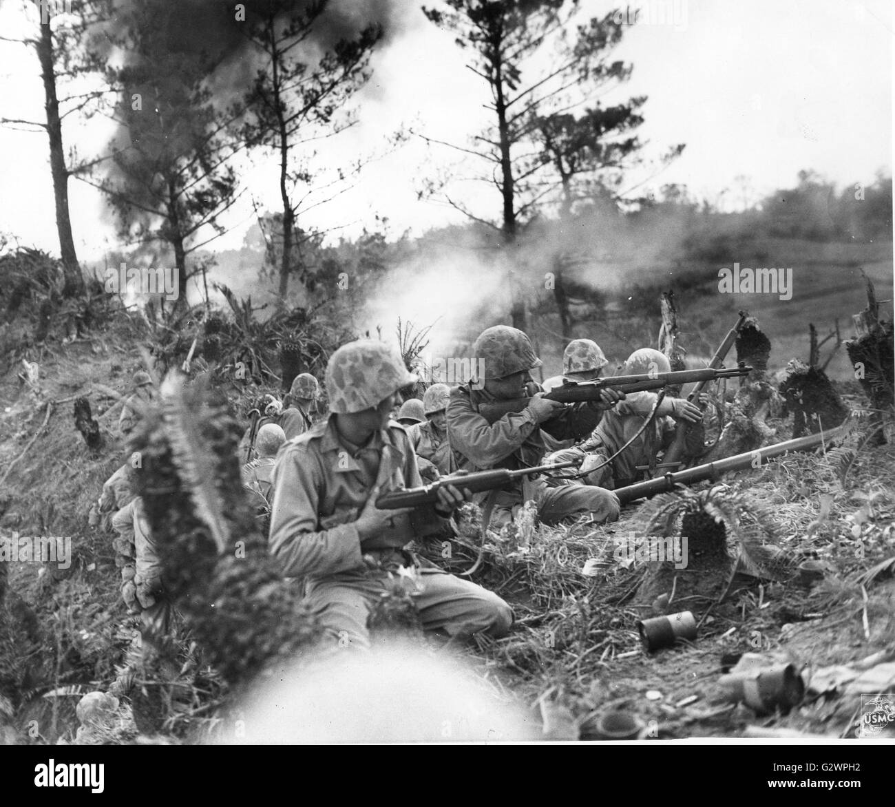 Marines battled a strong enemy force two miles north of the city of Naha on Okinawa for 48 hours before the position was captured. Here amid shellbursts and rifle fire, the Leathernecks prepare for the drive into the town. Stock Photo