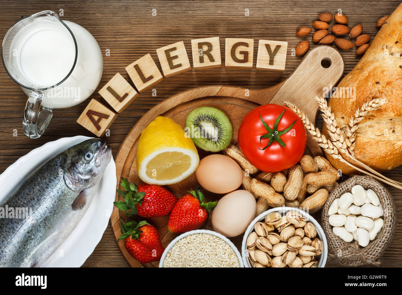 Allergy food concept. Allergy food as almonds, milk, pistachios, tomato, lemon, kiwi, trout, strawberry, bread, sesame seeds, eg Stock Photo