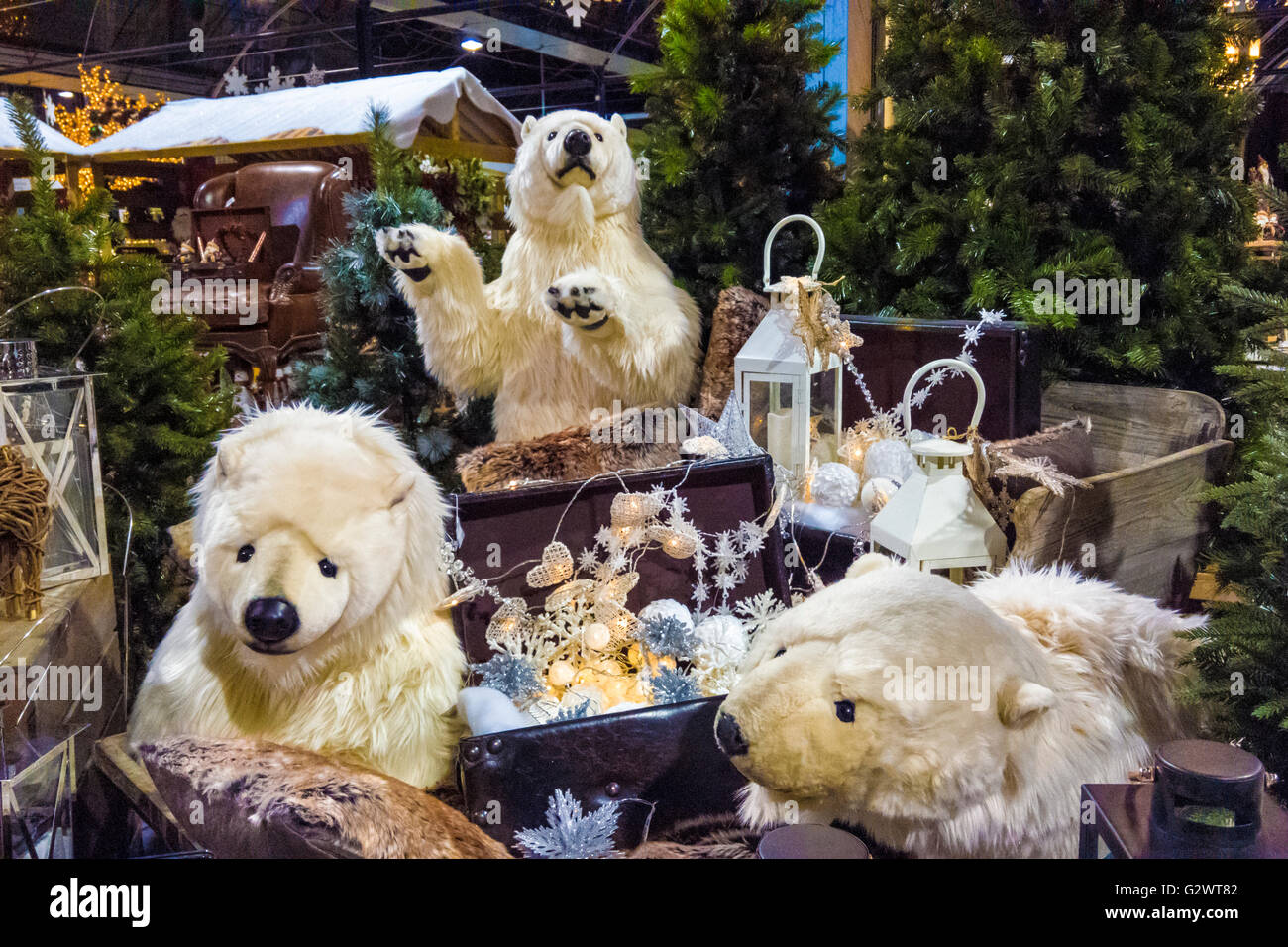 Large Polar Bear cuddly toys on display with Christmwas decorations at a garden centre. Stock Photo