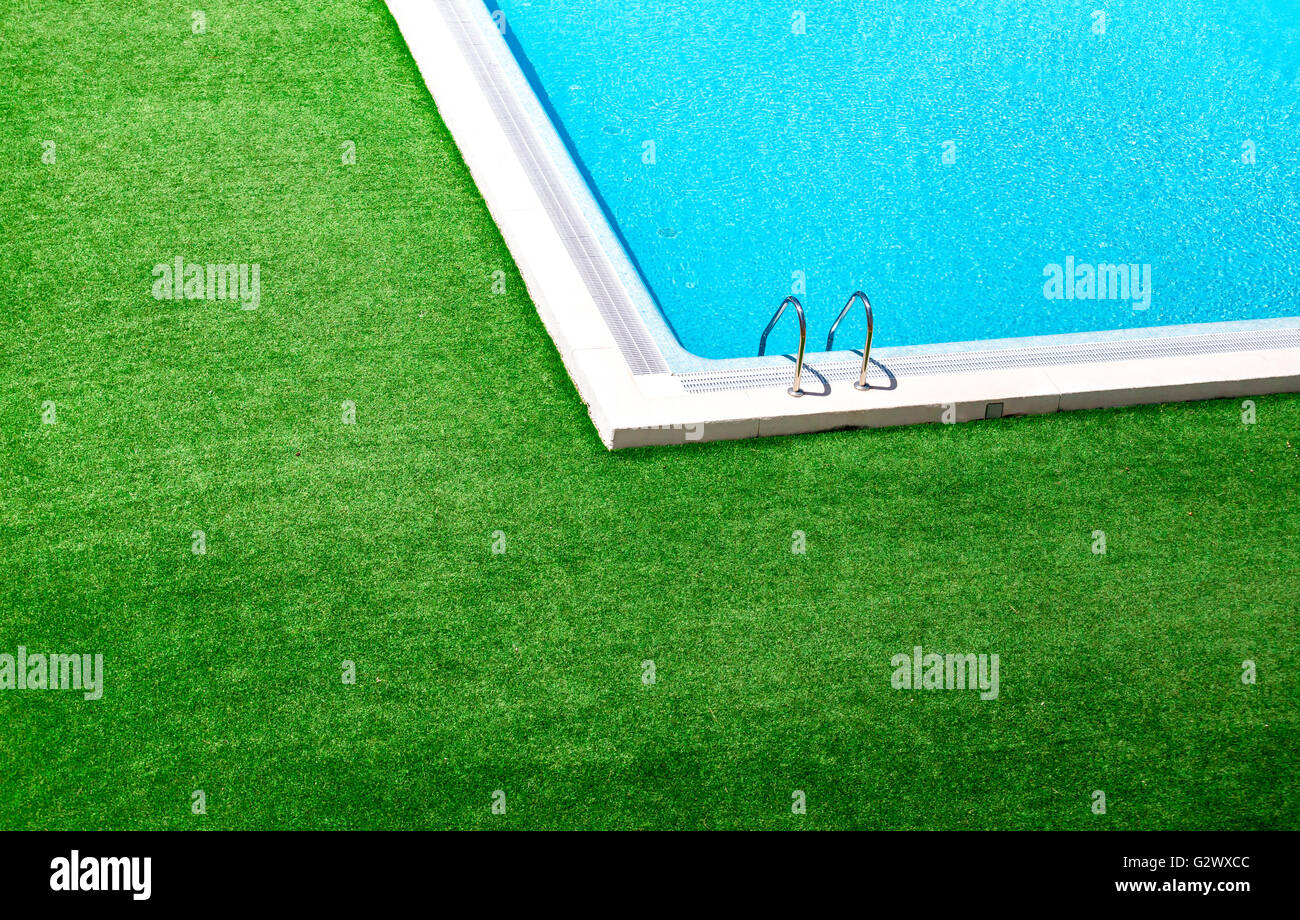 Beautiful swimming pool with green grass around Stock Photo - Alamy
