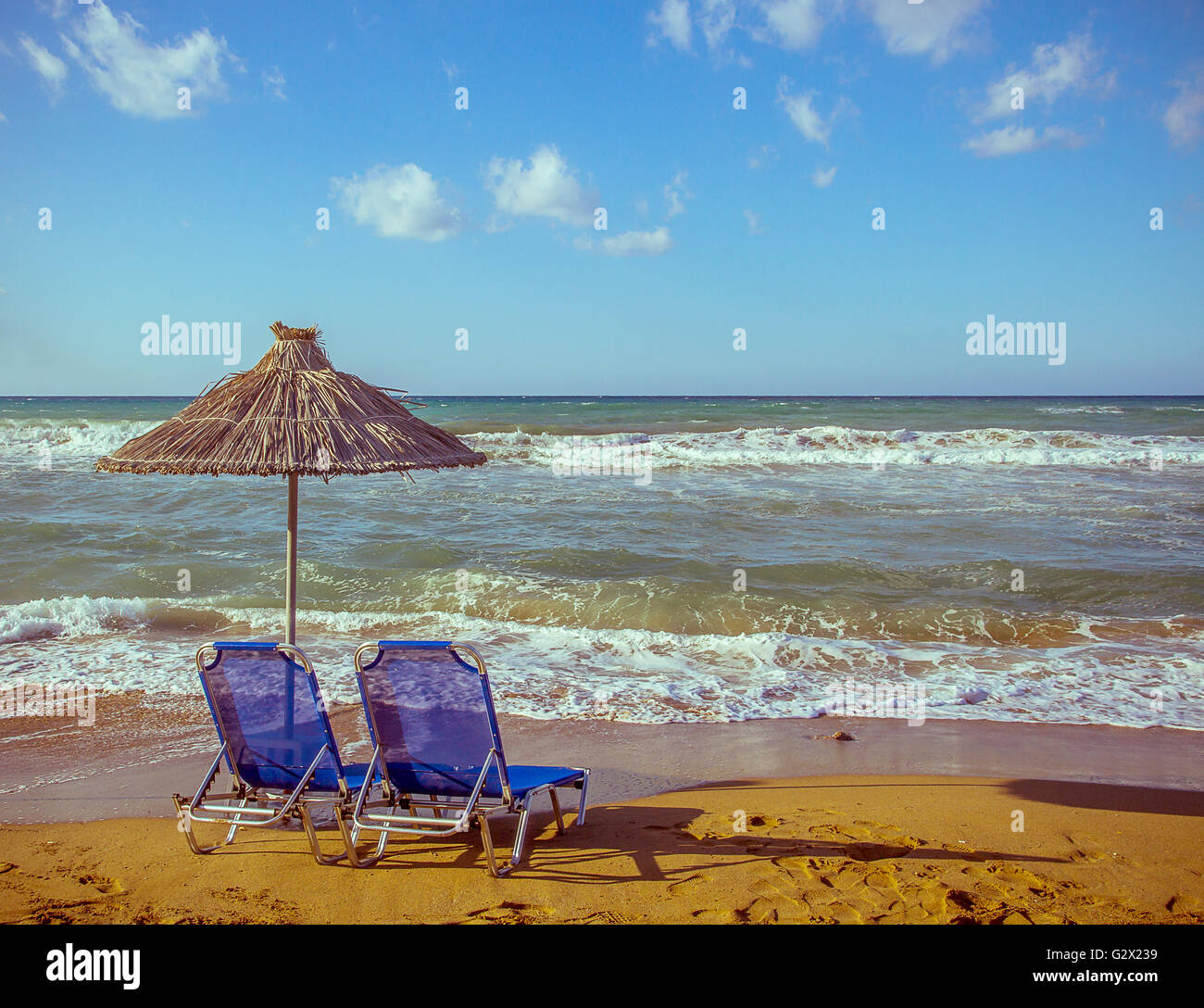 Two empty beach chair with umbrella on blue sea Stock Photo
