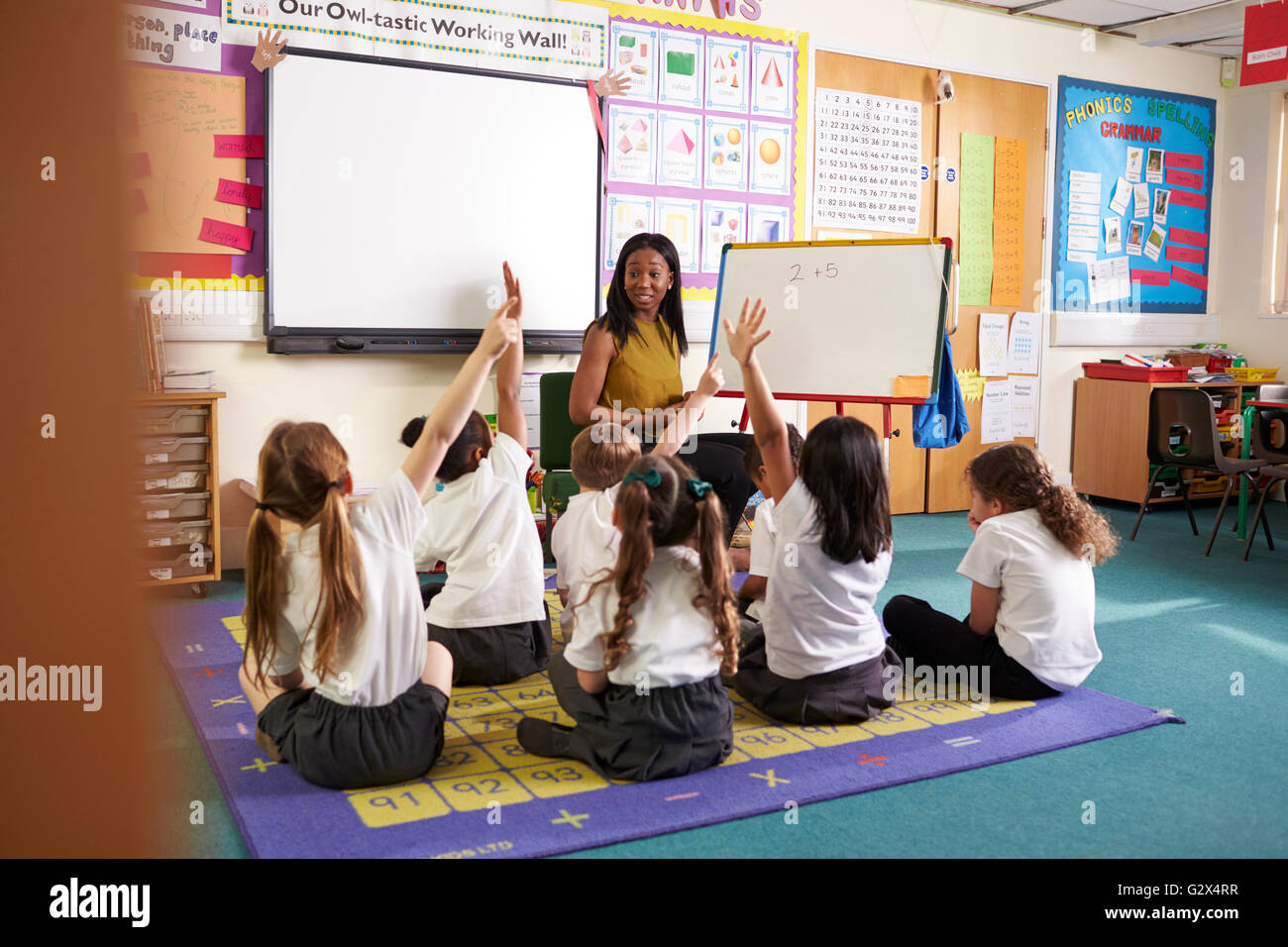 Teacher With Whiteboard In Elementary School Maths Class Stock Photo