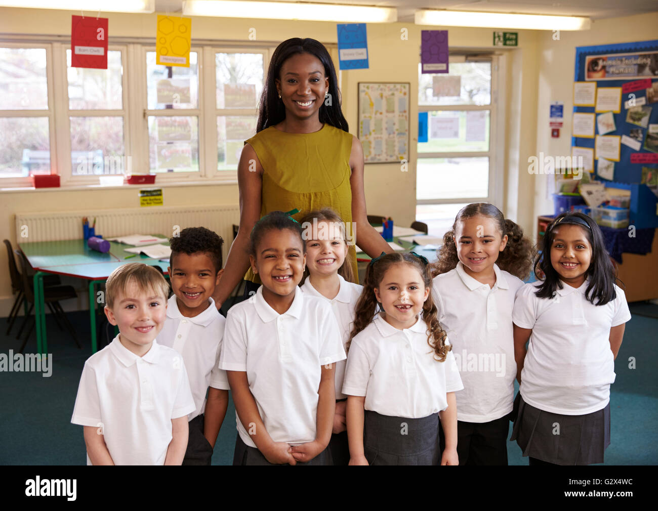 Portrait Of Elementary Pupils And Teacher In Classroom Stock Photo