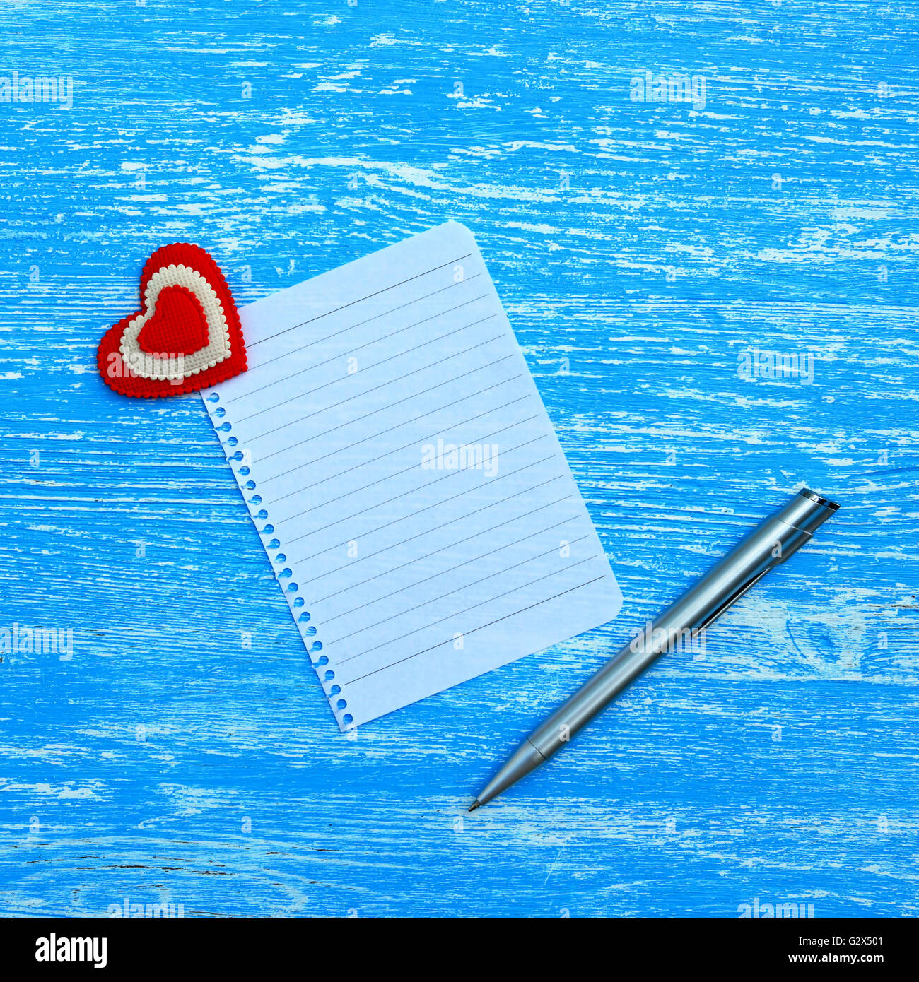 Blank sheet of paper and hearts on a blue wooden background Stock Photo