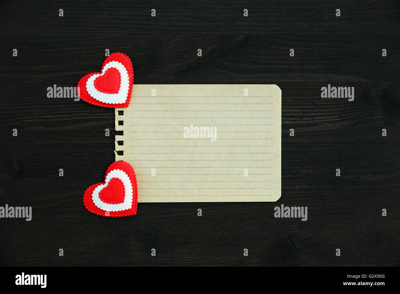 Love background. A blank sheet of paper and two hearts on a wooden ...