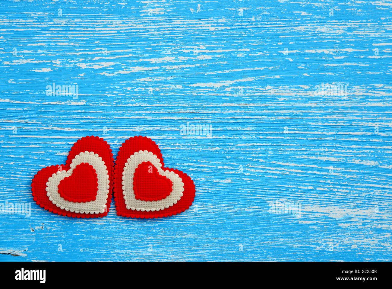 Red hearts on a blue wooden background Stock Photo - Alamy