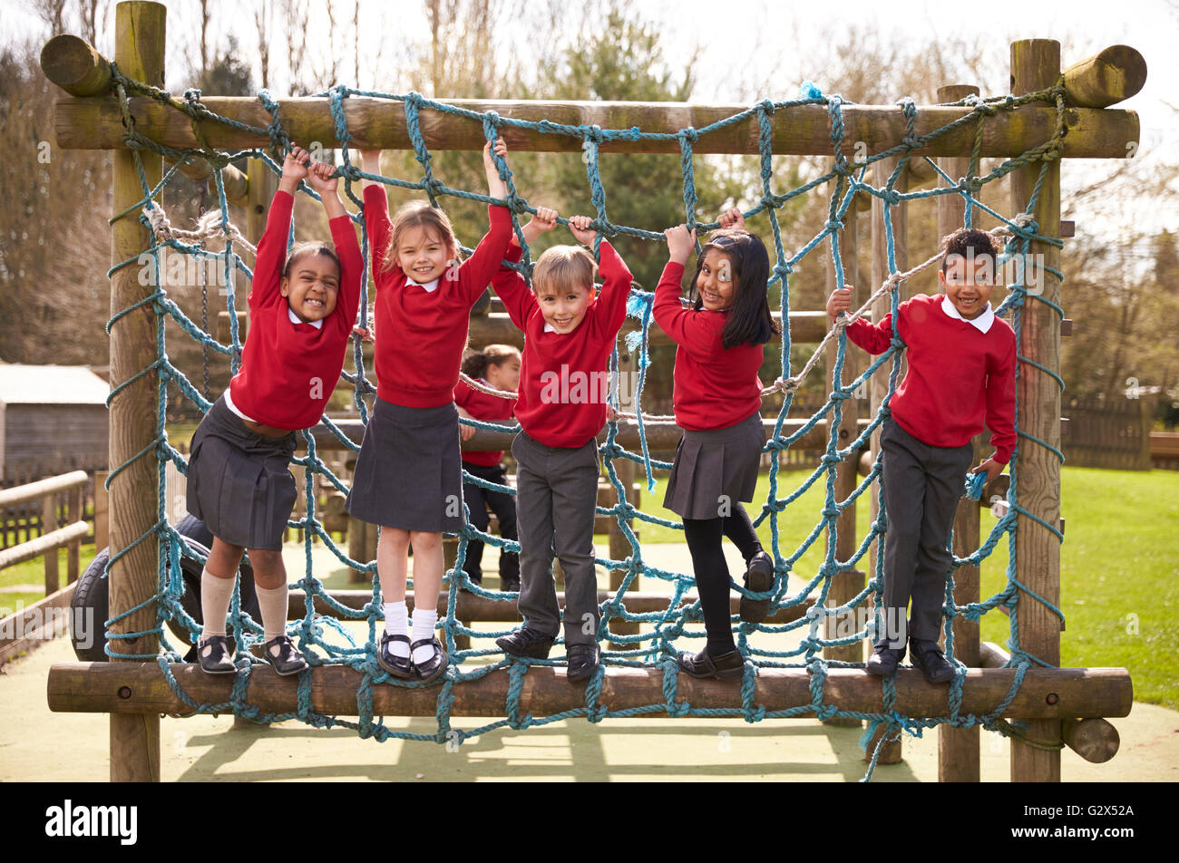 Elementary School Pupils Play On Climbing Frame At Breaktime Stock Photo