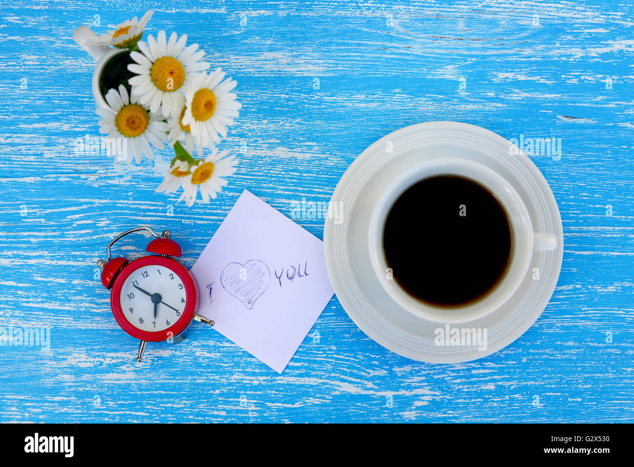 https://c8.alamy.com/comp/G2X530/daisy-flowers-alarm-clock-and-cup-of-coffee-with-i-love-you-note-on-G2X530.jpg