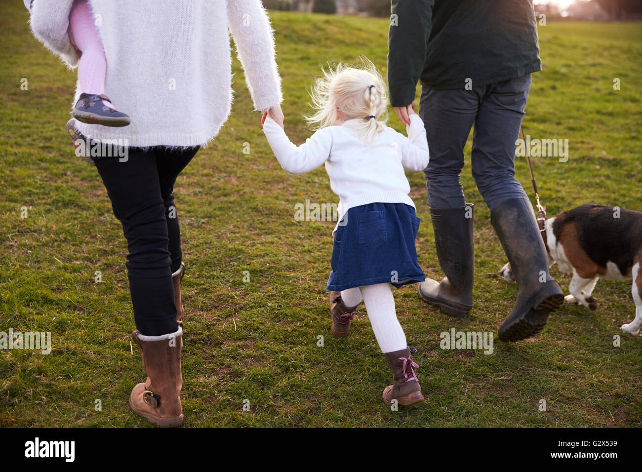 Family On Winter Country Walk With Pet Dog Stock Photo