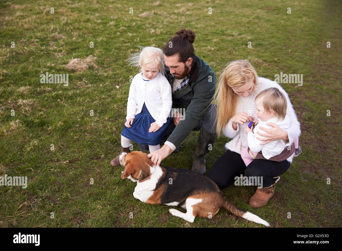 Family On Winter Country Walk With Pet Dog Stock Photo