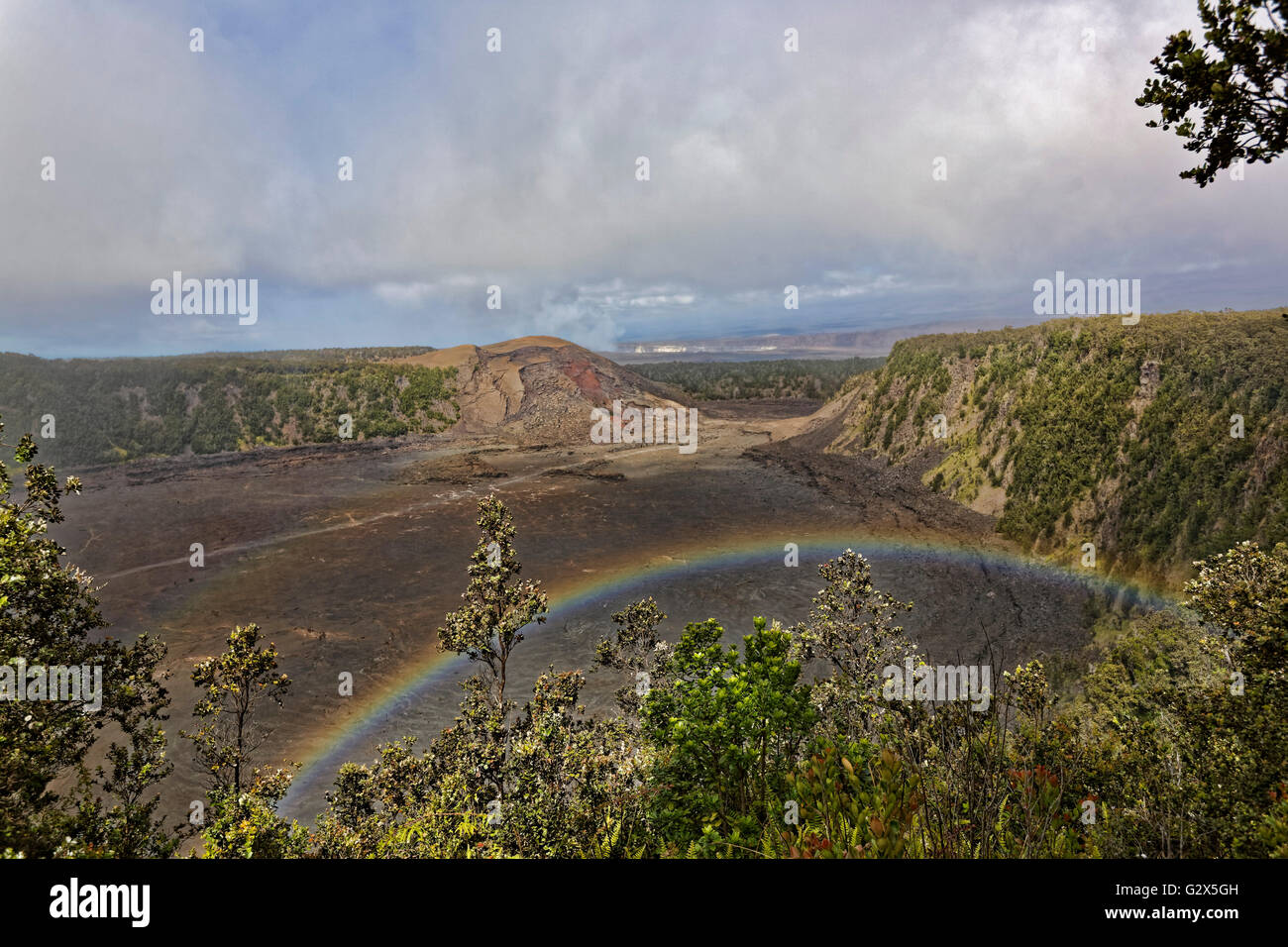 Rainbow over volcano crater at the Hawaii volcanoes national park Stock Photo