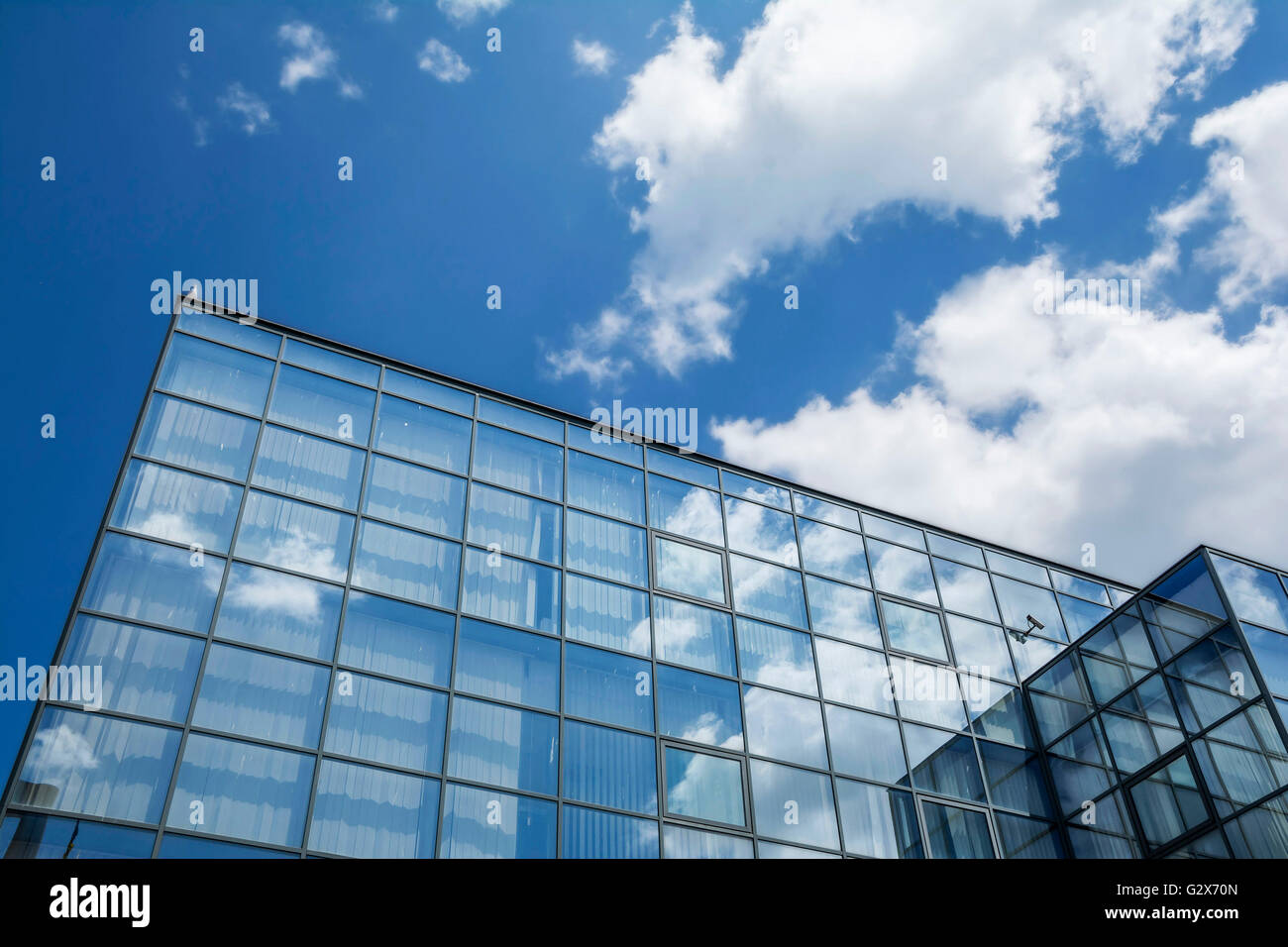 Building facade with blue sky and white clouds Stock Photo - Alamy