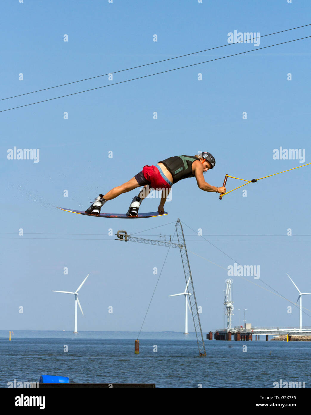 Wakeboarder at Copenhagen Cable Park. Middelgrunden Offshore Wind Farm
