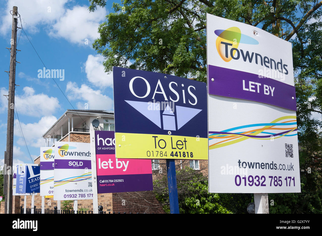 Estate agent signs outside apartments, Staines Road West, Sunbury-on-Thames, Surrey, England, United Kingdom Stock Photo