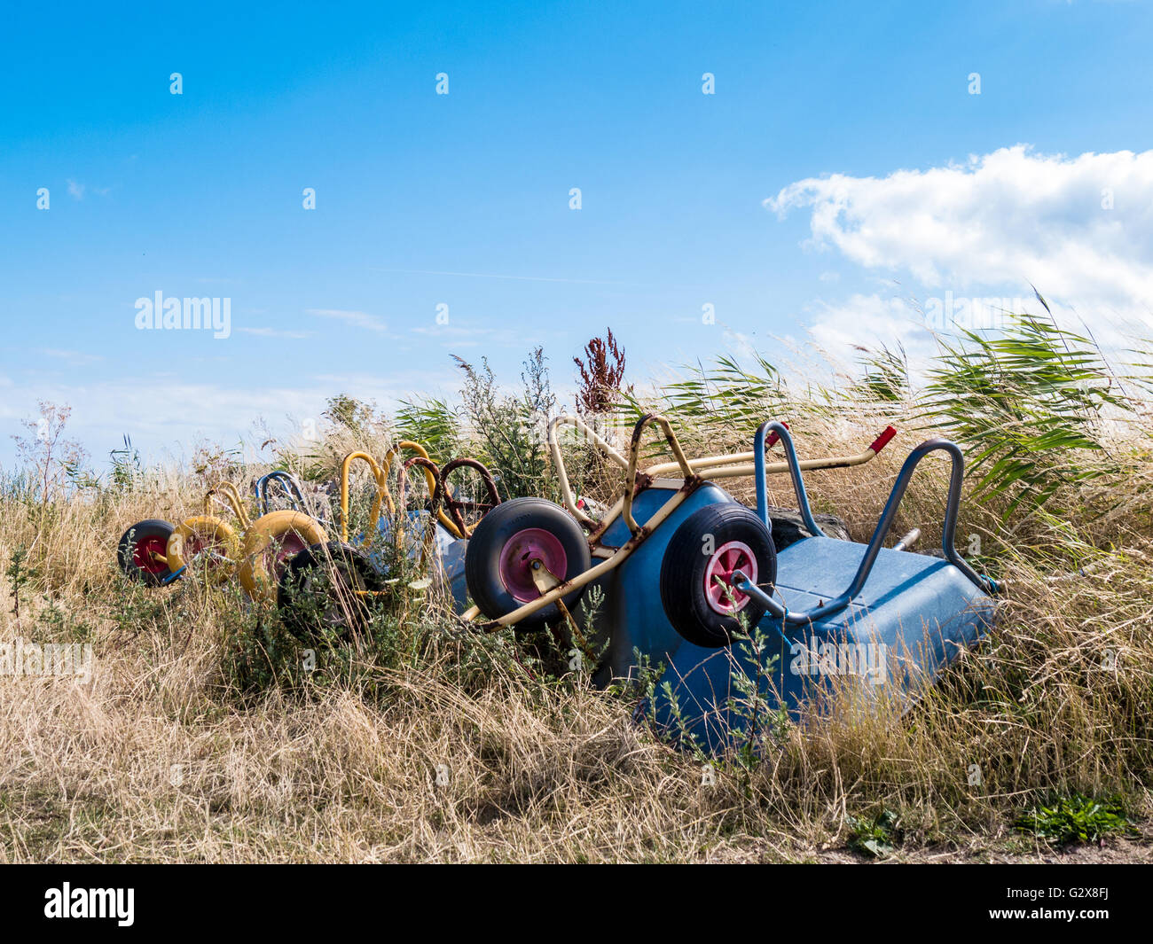 Pushcarts in grass with blue sky Stock Photo