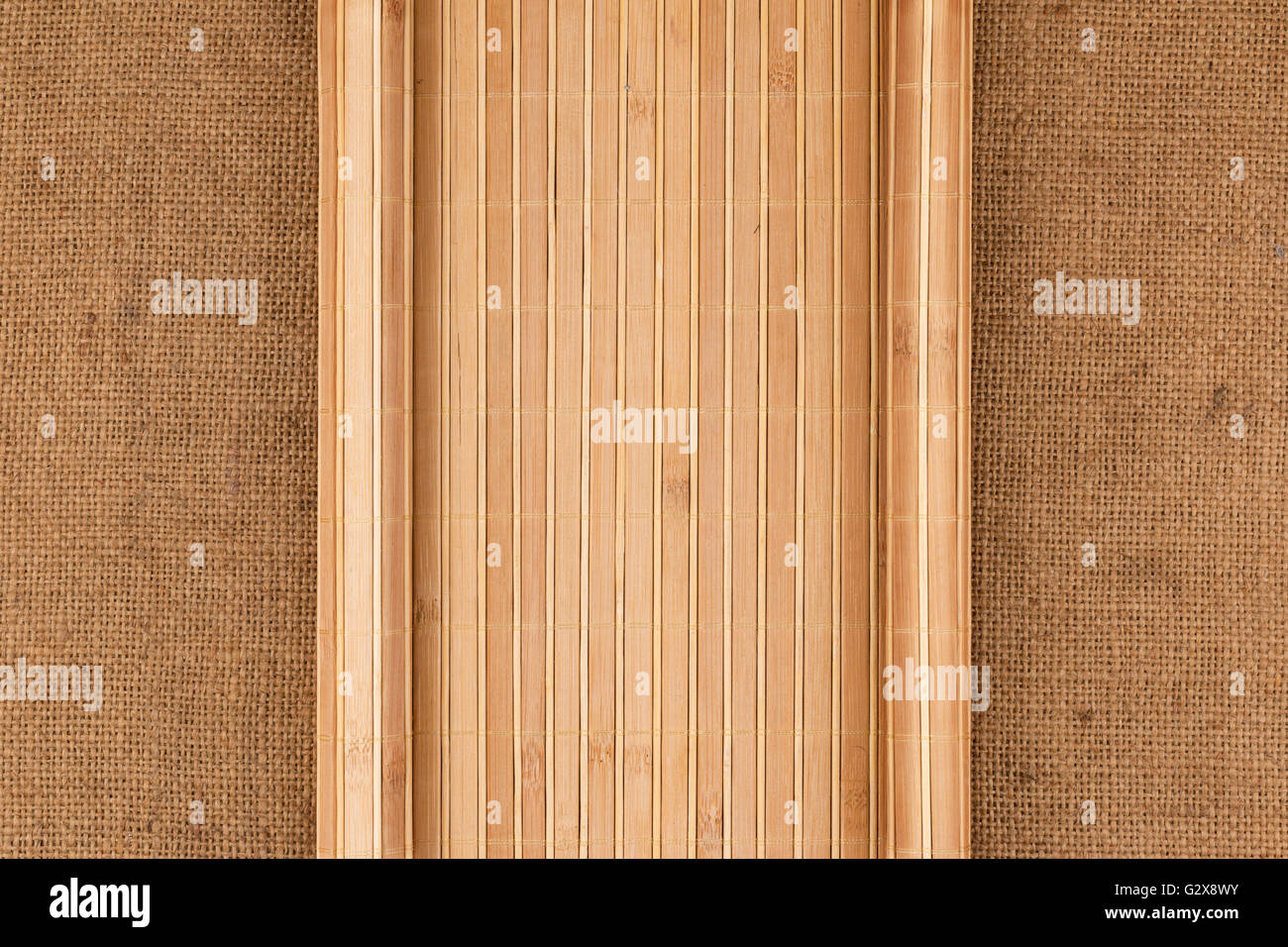 Bamboo mat in the form of a manuscript on sackcloth, top view Stock Photo