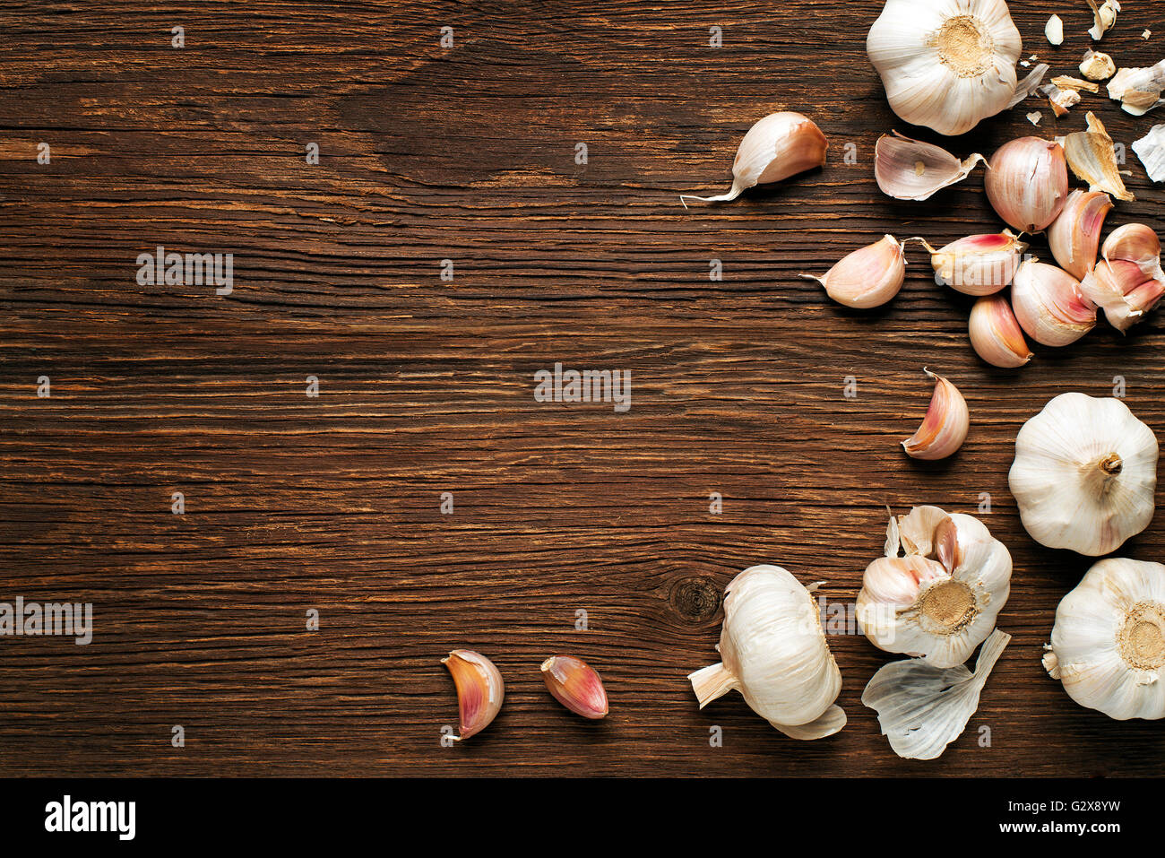 Garlic cloves on a vintage wooden background Stock Photo - Alamy