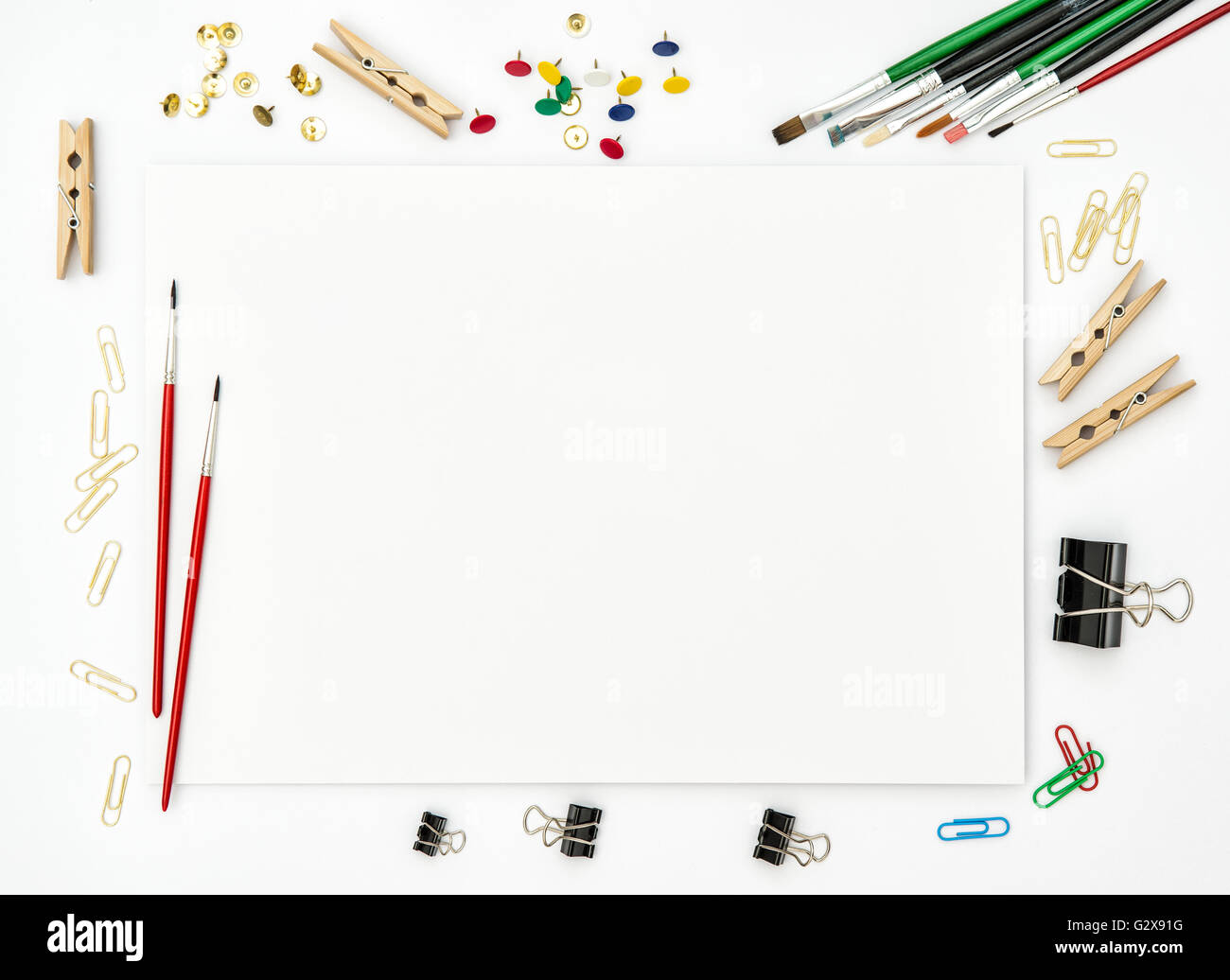 Sketchbook, brushes, paper, office supplies on white background. Flat lay. Creative art concept Stock Photo