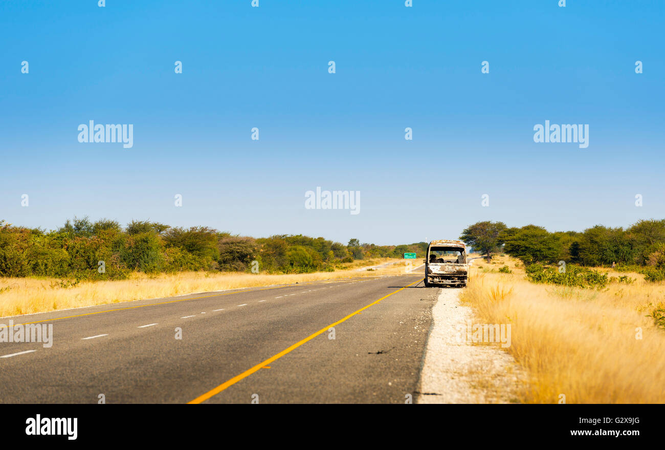 Burned out car on a highway in Botswana while travelling through Africa Stock Photo