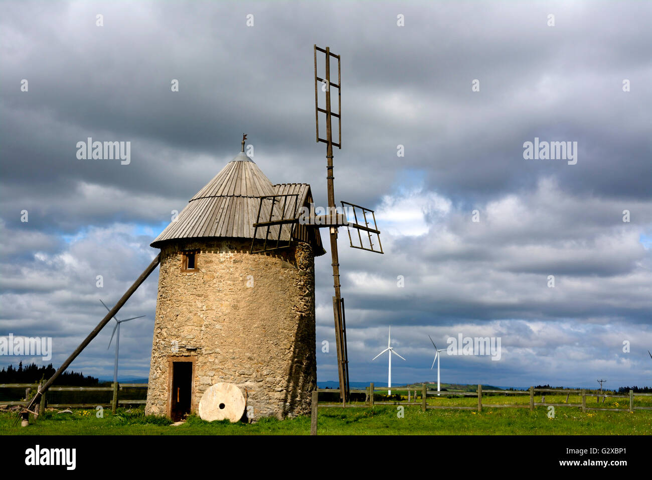 Traditional windmill, wind turbines of the Ally Mercoeur Wind Farm at the back, near Ally, Haute-Loire department, Auvergne Stock Photo