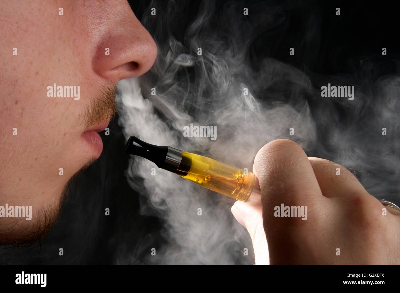 Man smoking an electronic cigarette and exhaling vapour Stock Photo Alamy