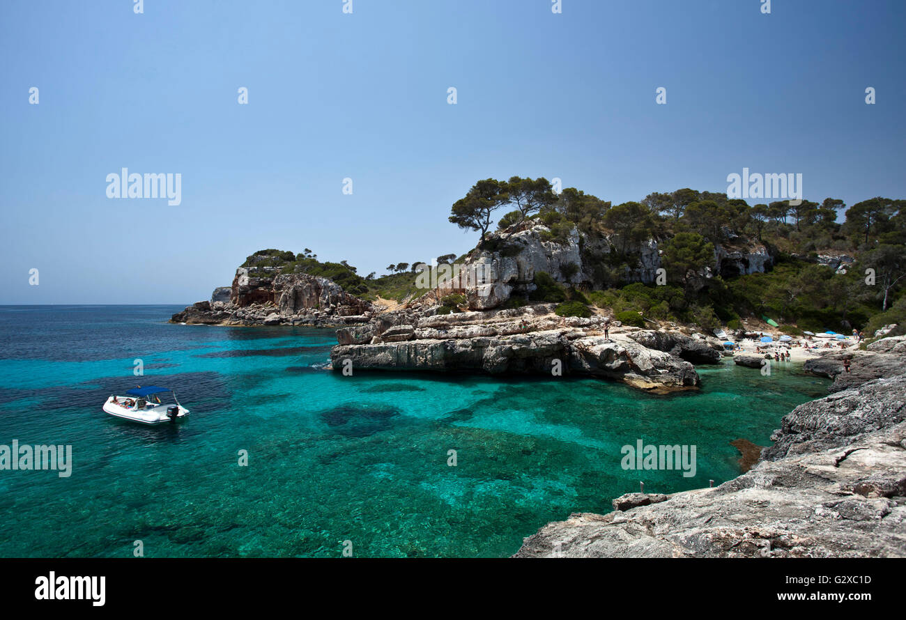 Boat in the rock-lined bay of Calo des Moro, Santanyi, Mallorca, Majorca, Balearic Islands, Spain Stock Photo