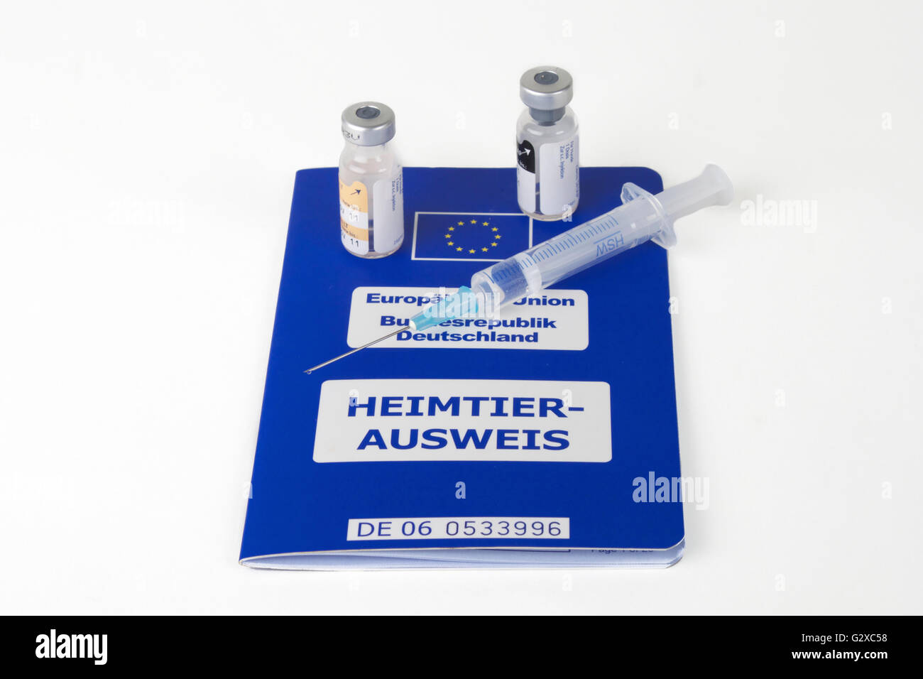 A syringe and vials on an EU pet passport, Germany Stock Photo Alamy