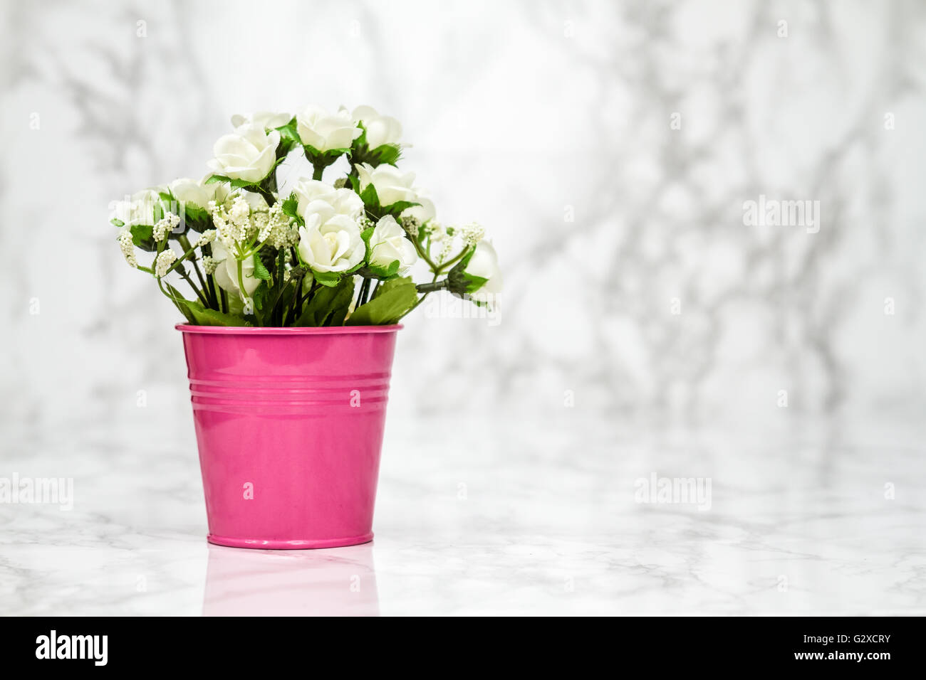 Small decorative artificial white flowers in pink pot Stock Photo Alamy