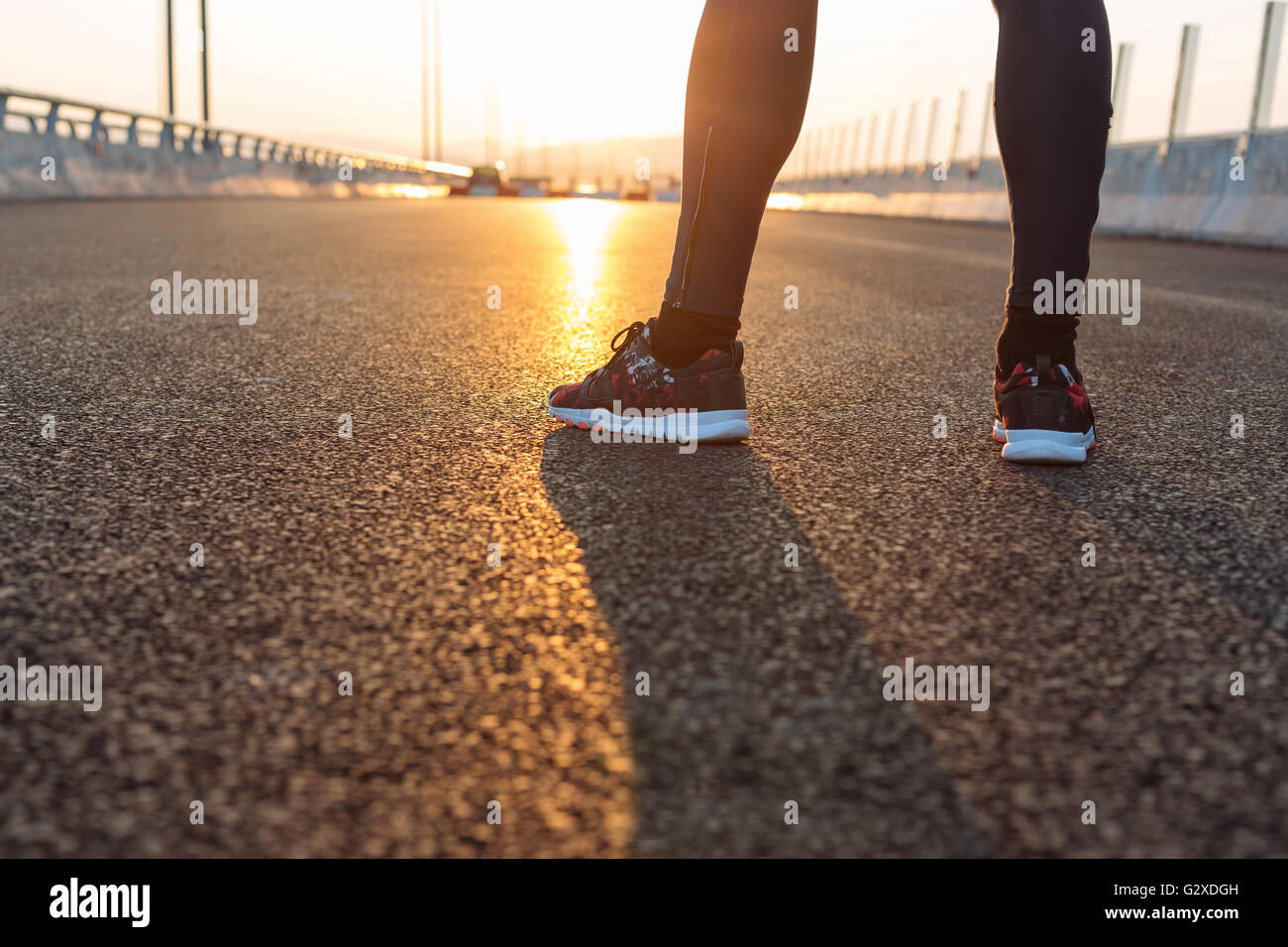 feet of an athlete running on a park pathway training for fitness and ...