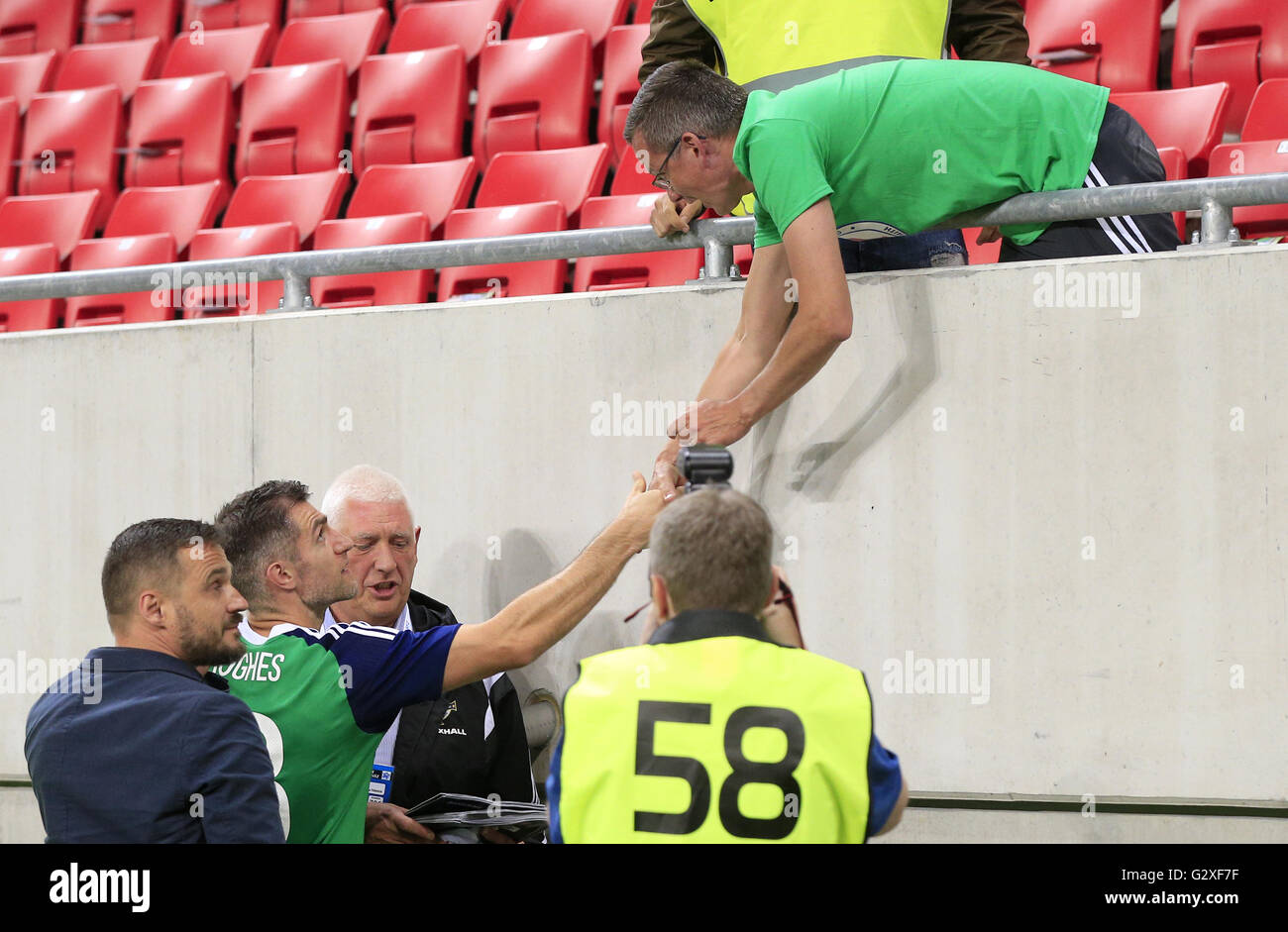 Northern Ireland's Aaron Hughes greets a fan after the final whistle during the International Friendly match at the Antona Malatinskeho Stadium, Trnava, Slovakia. PRESS ASSOCIATION Photo. Picture date: Saturday June 4, 2016. See PA story SOCCER Slovakia. Photo credit should read: Jonathan Brady/PA Wire. Stock Photo