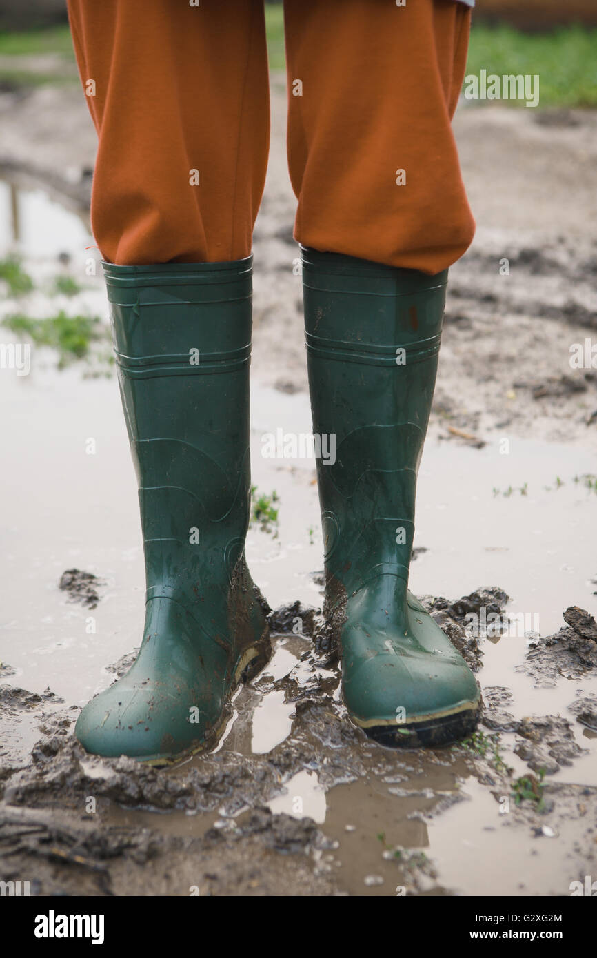 woman in rubber boots standing in a puddle Stock Photo - Alamy
