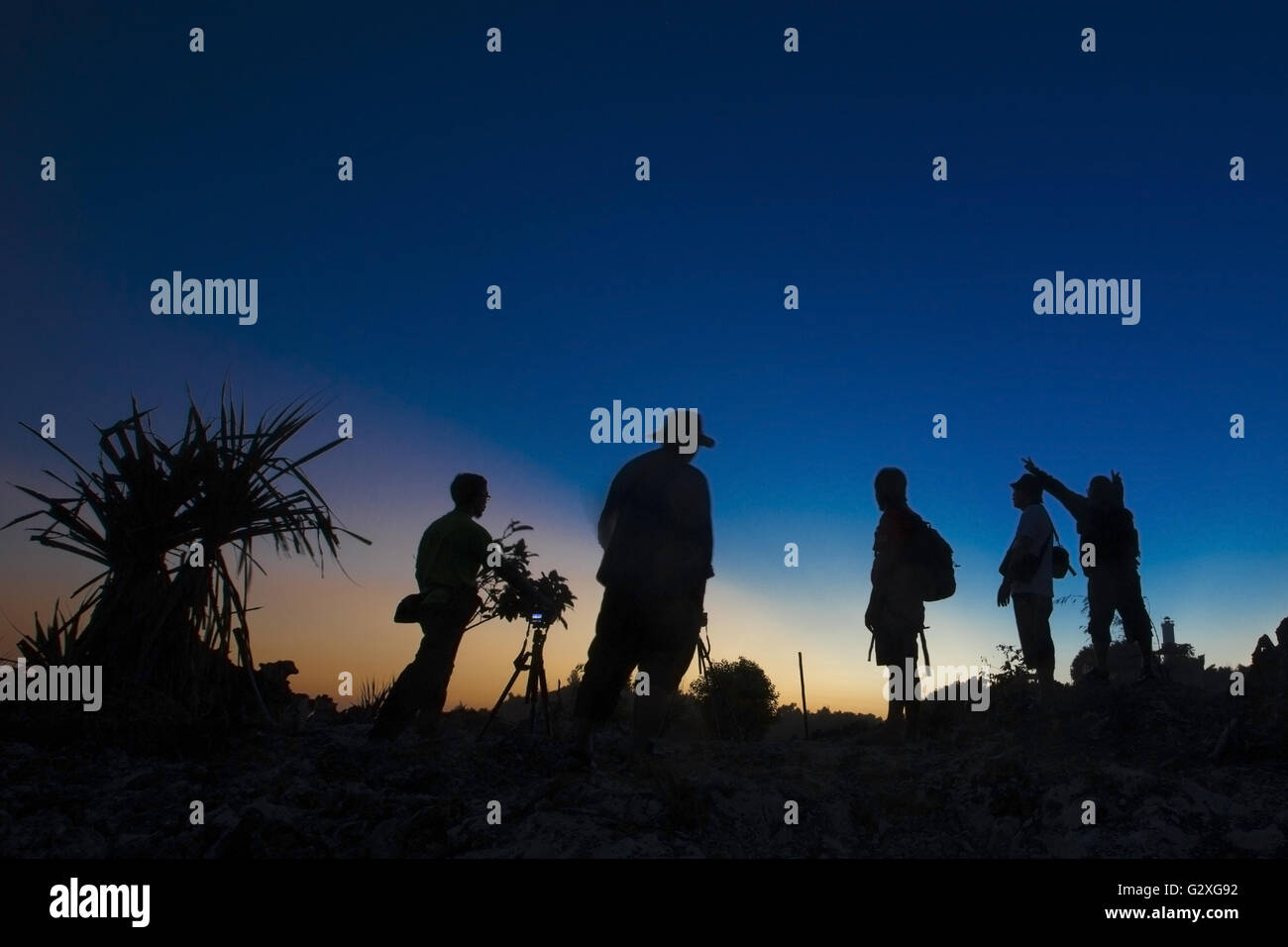 A silhouette  of group people watching sunset. Stock Photo
