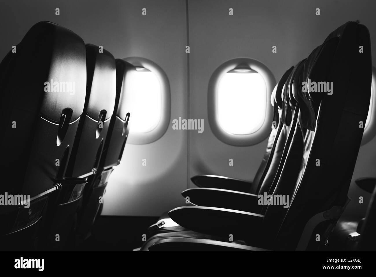 Airplane seat and window inside an aircraft Stock Photo