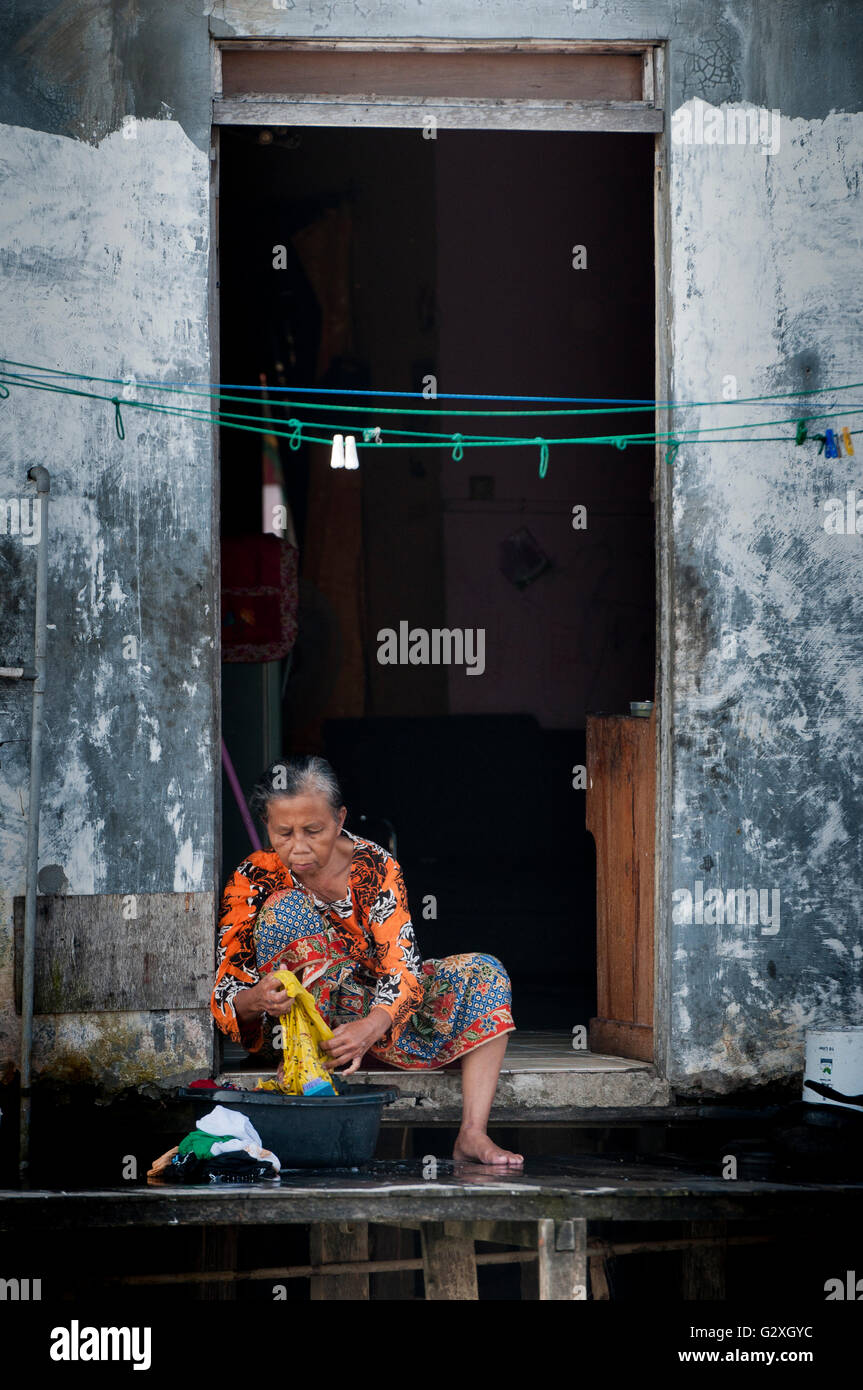 Kalimantan, Banjarmasin, Barito River, Woman Washing Clothes In The River Stock Photo