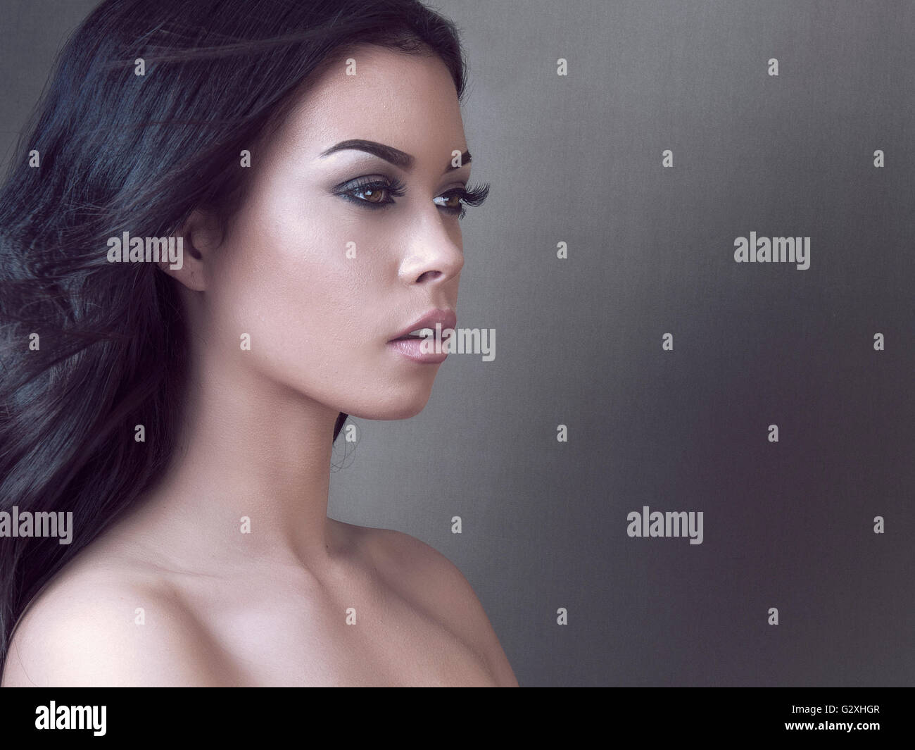 3d illustration of an exotic woman with a dark hair, black makeup and no  eyebrows on a black background Stock Photo - Alamy