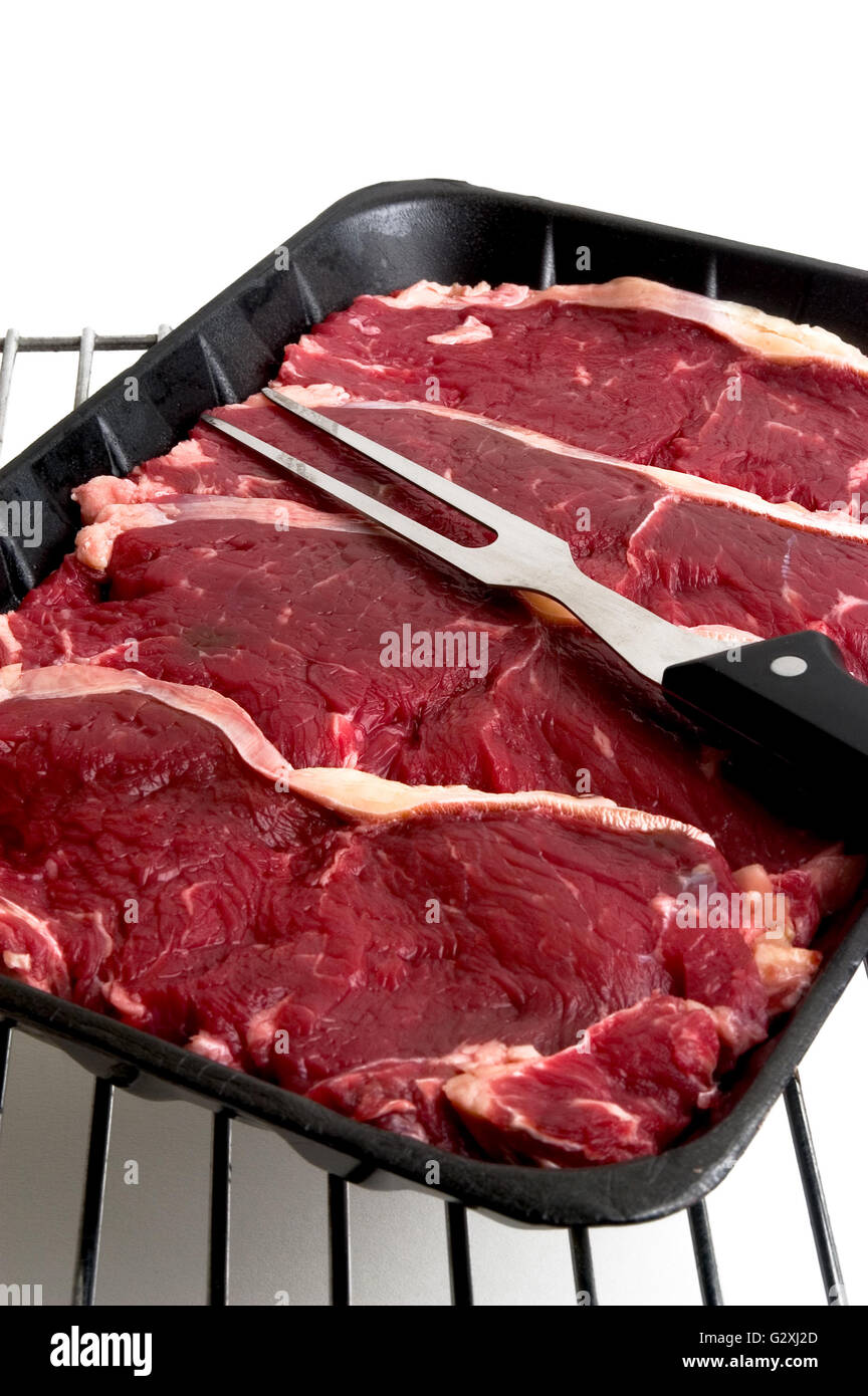 Beef steak on rack ready to be grilled photograph in the studio on ...