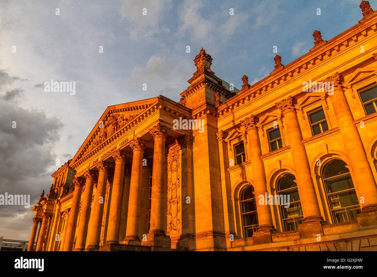 The exterior of the Reichstag building home of the German Parliament ,glowing in the setting sun , Berlin. Germany Stock Photo