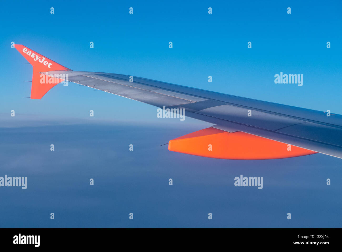 The wing tip of and easyJet Airbus plane flying over Europe Stock Photo ...
