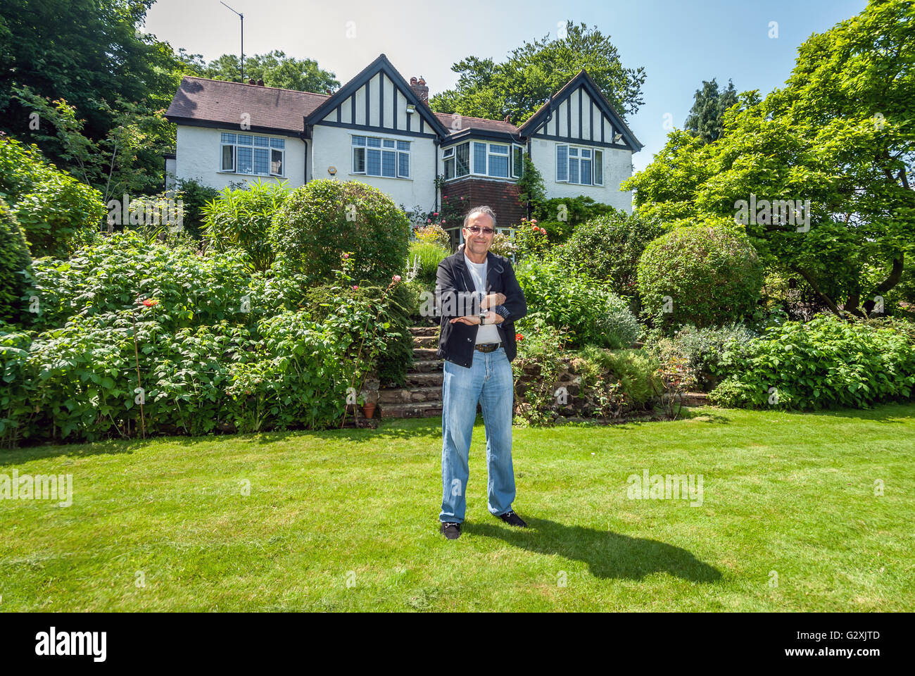 Crime writer Peter James in the garden of the Brighton house he was brought up in Stock Photo