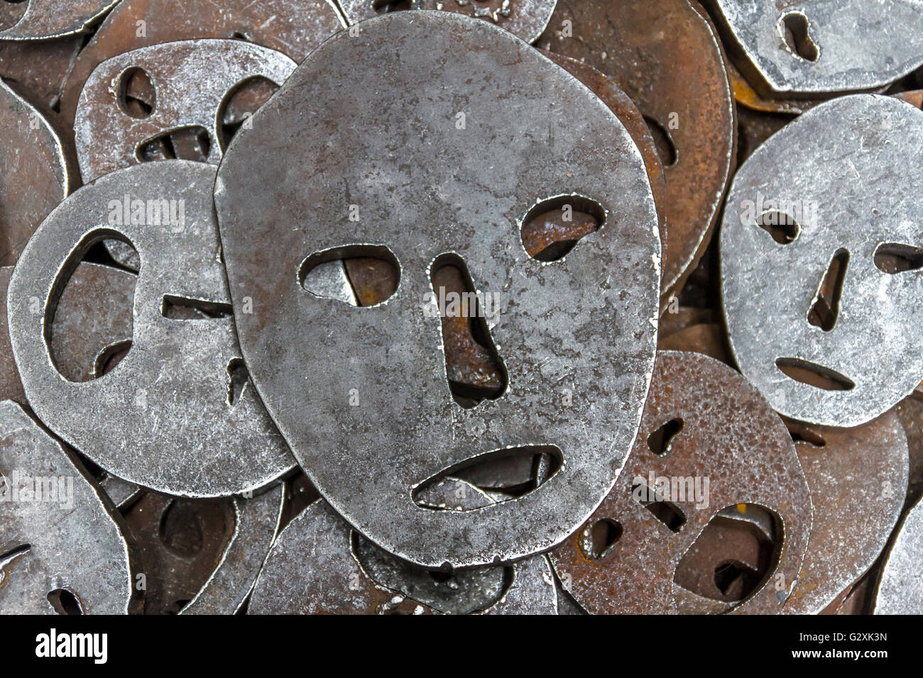 Shalekhet - fallen leaves, installation of metal faces with open mouths, cut from heavy round iron plates covers the floor,in The Jewish Museum Berlin Stock Photo