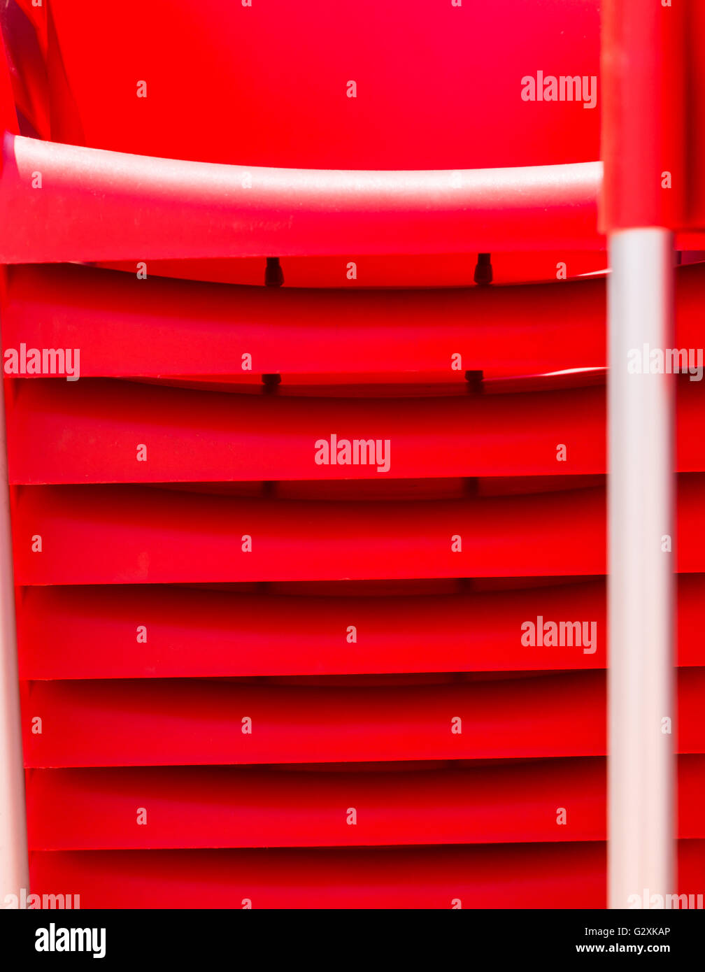 details of stack red chairs from hard plastic. abstract form for design or background Stock Photo