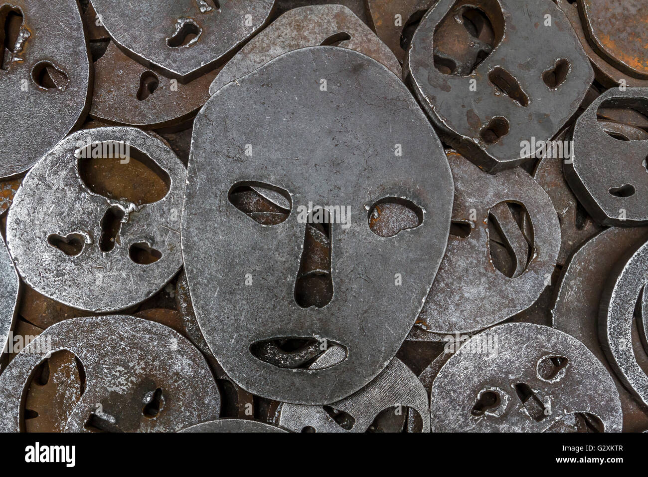 Shalekhet - fallen leaves,installation of metal faces with open mouths, cut from heavy round iron plates covers the floor,in The Jewish Museum Berlin Stock Photo