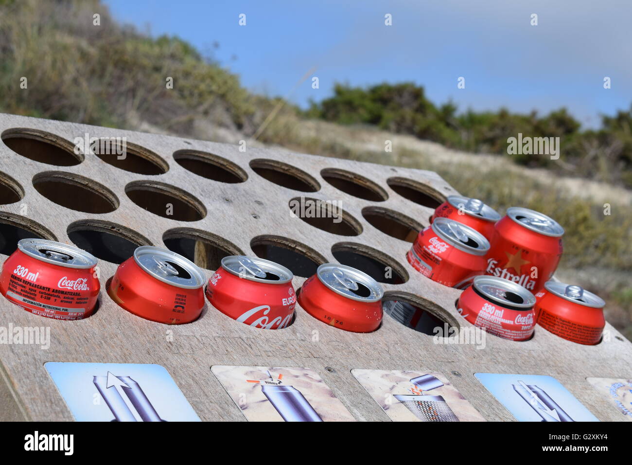 Coke and beer cans recycled as cigarette ash trays Stock Photo