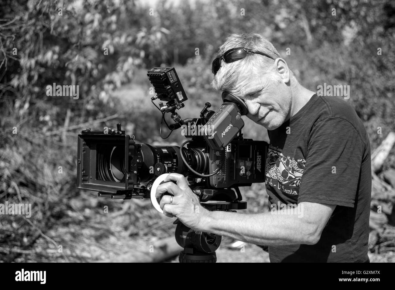 Tom, DP framing up the shoot. Working with the Arri Amira video camera and the Zeiss 70-200mm CP2 zoom lens. Stock Photo