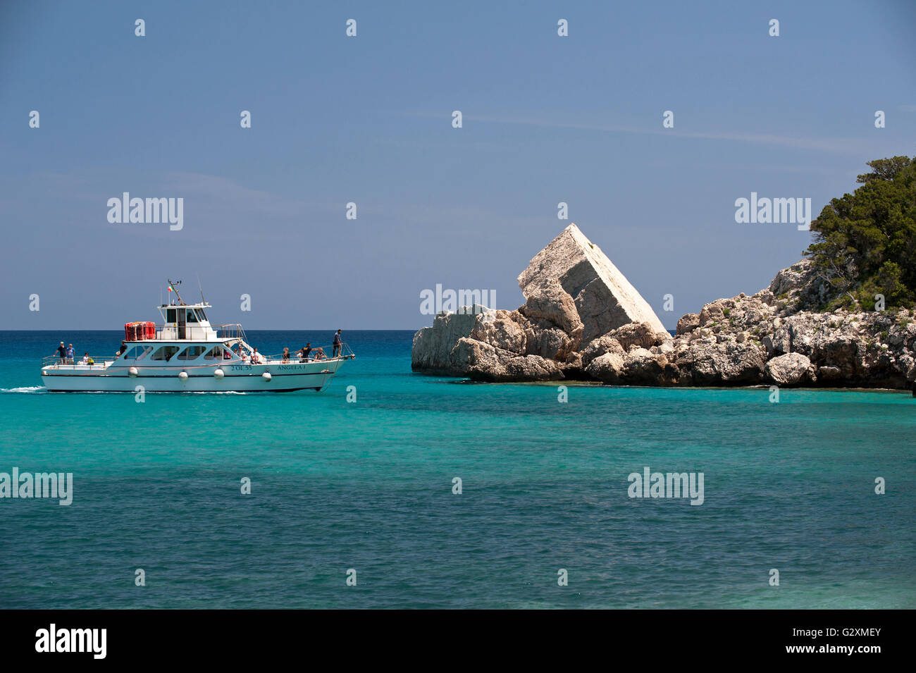Cala Gonone,Dorgali,Sardinia,Italy, 25/5/2016.A boat sails along the rocky coast at the famous Cala Luna beach, Orosei gulf. Stock Photo