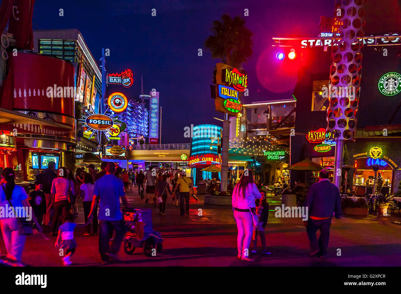 Brightly colored neon signs of clubs and restaurants light up Universal Studio's City Walk in Orlando, Florida Stock Photo