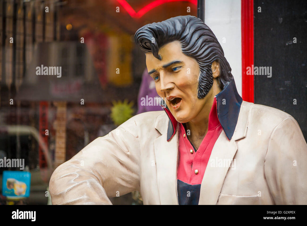 Statue of Elvis Presley on sidewalk outside of Dixieland Delights gift and souvenir shop in