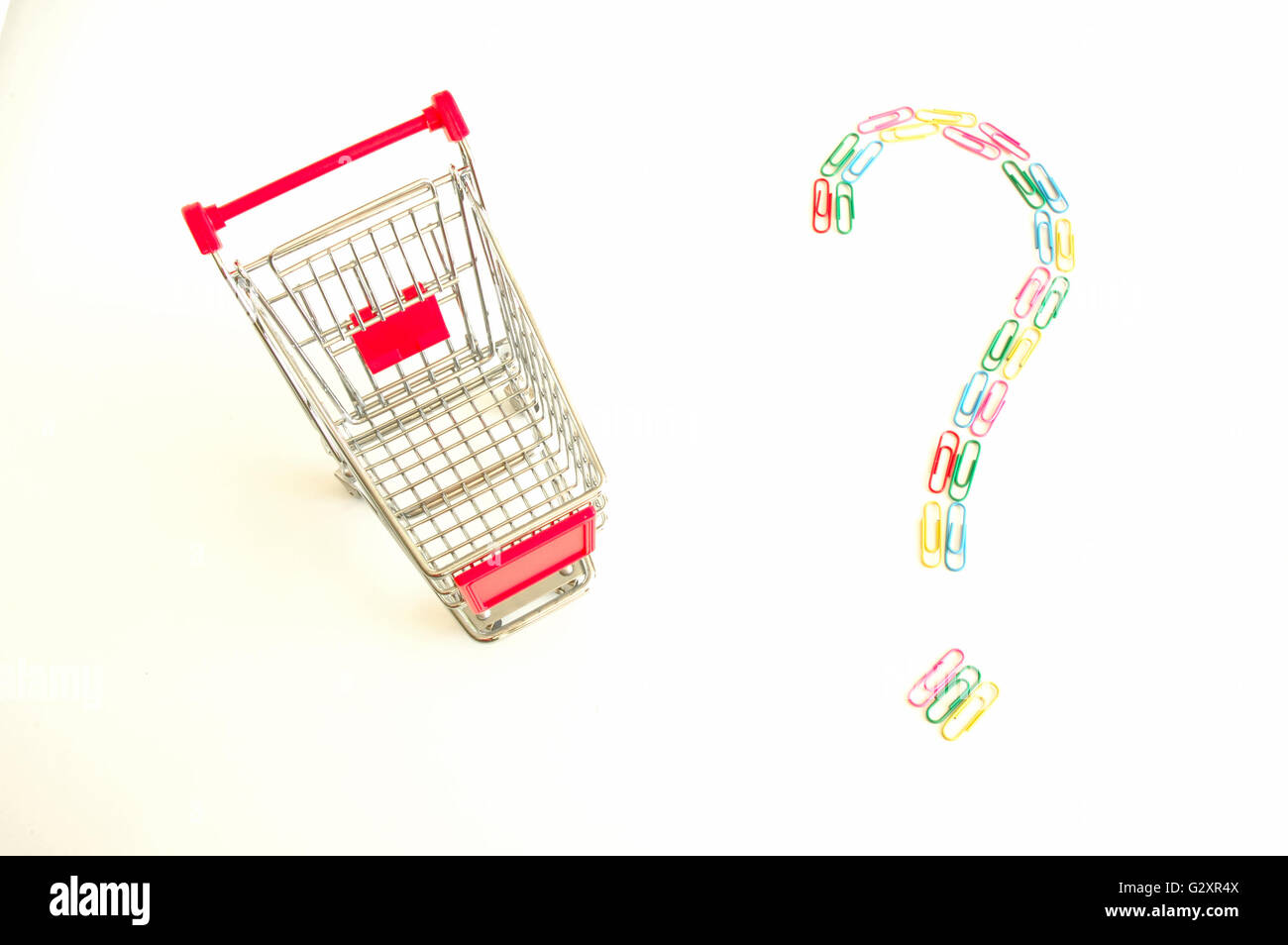 Shopping cart and question mark made of colourful paper clips Stock