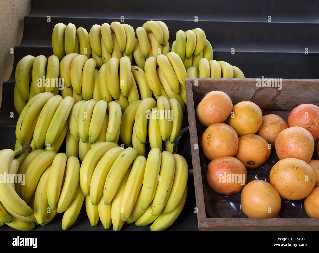 Bananas and grapefruit on display in a market Stock Photo
